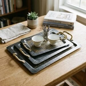 Decorative steel tray set with intricate engraved design, ideal for serving and home decor.